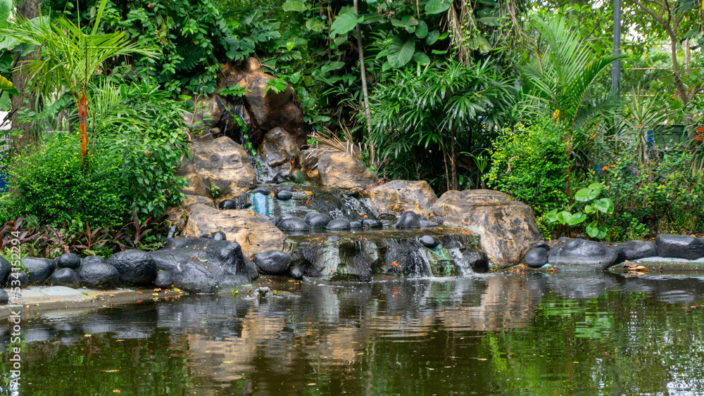 artificial waterfall at the city park. Hand made waterfall artificial waterfall at the city park. Hand made waterfall