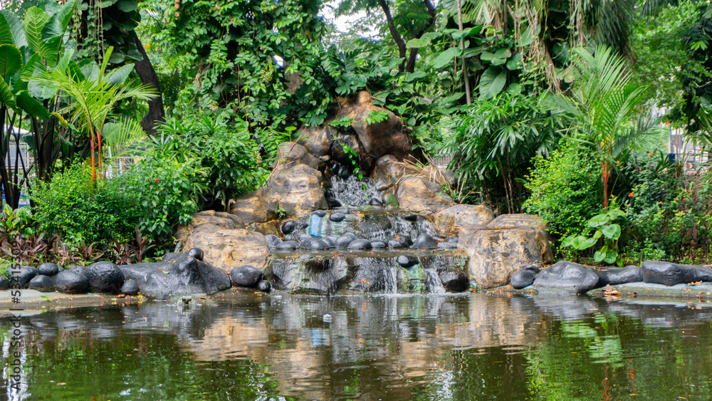 artificial waterfall at the city park. Hand made waterfall artificial waterfall at the city park. Hand made waterfall
