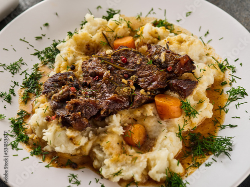 Slika na platnu Beef cheeks with mashed potatoes on white plate.