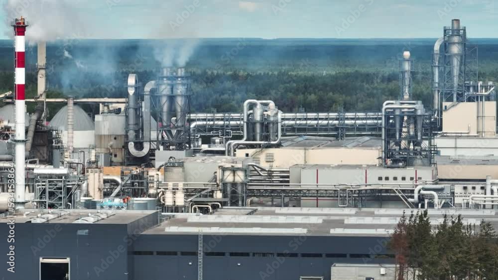 flight near pipes with white smoke of woodworking enterprise plant sawmill. Air pollution concept on industrial landscape flight near pipes with white smoke of woodworking enterprise plant sawmill. Air pollution concept on industrial landscape