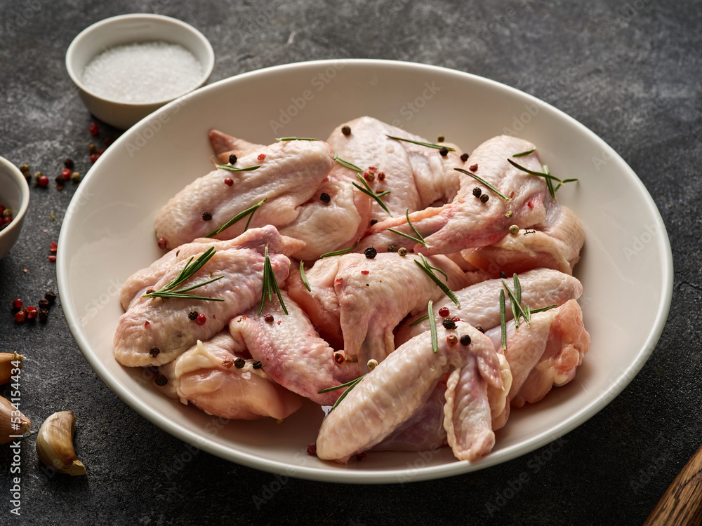 Uncooked chicken wings with spices. Raw meat. Raw Chicken wings. Uncooked chicken wings with spices. Raw meat. Raw Chicken wings.