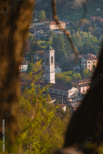 the alps, lakes and cities of brianza seen in the sunset light from the top of mount Barro, near the town of lecco, Italy - April 2022.