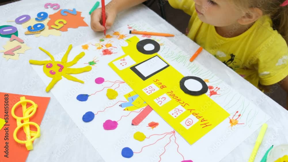 Child making school bus from paper and plasticine. Creative ideas for preschool. DIY. Back to school, happy time Child making school bus from paper and plasticine. Creative ideas for preschool. DIY. Back to school, happy time