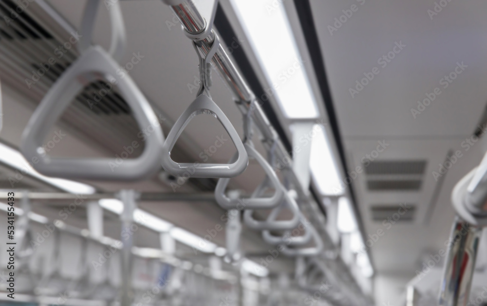 Handles for standing passenger inside in the subway train. Subway or Metro Handrail, Hand holding blue Handrail Handles for standing passenger inside in the subway train. Subway or Metro Handrail, Hand holding blue Handrail