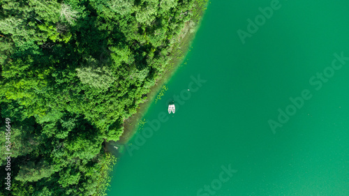 Boats on the green lake. Aerial drone view