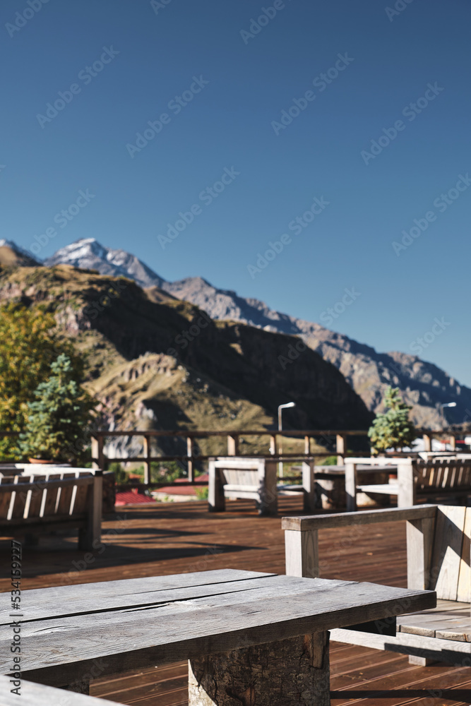Terrace with a beautiful view of the mountains, selective focus blurred background, Georgia high Caucasus, the idea of tourism and holidays in the mountains