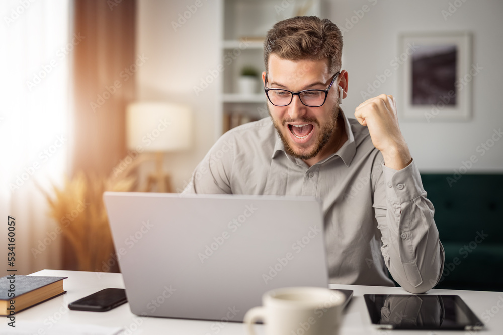Happy young bearded man excited about web success, smiling man reach goal, win concept Happy young bearded man excited about web success, smiling man reach goal, win concept