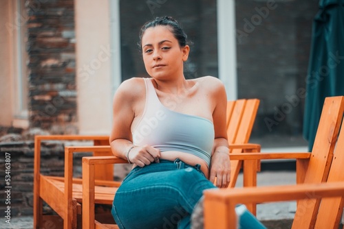 Young girl sitting on the bench photo