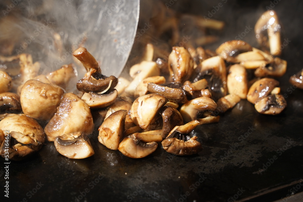 Roasting mushrooms on an open outdoor flat plate. Roasting mushrooms on an open outdoor flat plate.