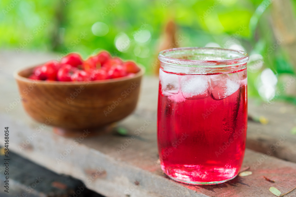 Glass of sour cherry juice with fresh red cherries, Cherry juice, on wood background, red drink, High vitamin C and antioxidant fruits. Glass of sour cherry juice with fresh red cherries, Cherry juice, on wood background, red drink, High vitamin C and antioxidant fruits.