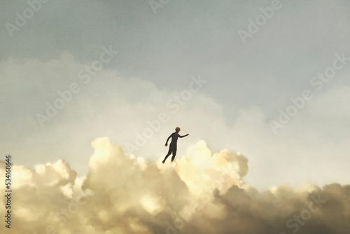 surreal boy has fun walking above the clouds