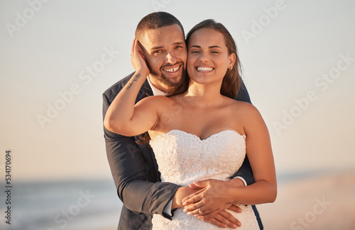Wedding, couple and hug on beach marriage celebration of love, support and commitment on Bali honeymoon vacation. Portrait of married man and woman celebrate, joy and happiness on Hawaii sea holiday