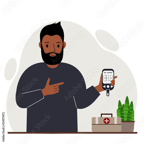 Happy man holds a glucometer in his hand. The concept of blood sugar control, diabetic.