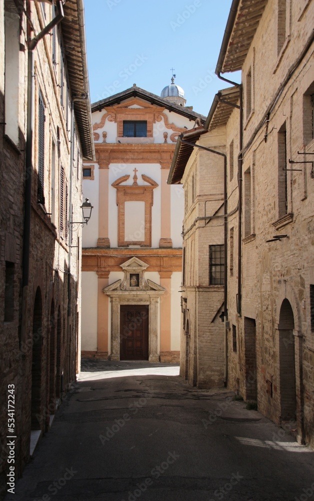 Italy, Umbria: Old street with Church in Bevagna.