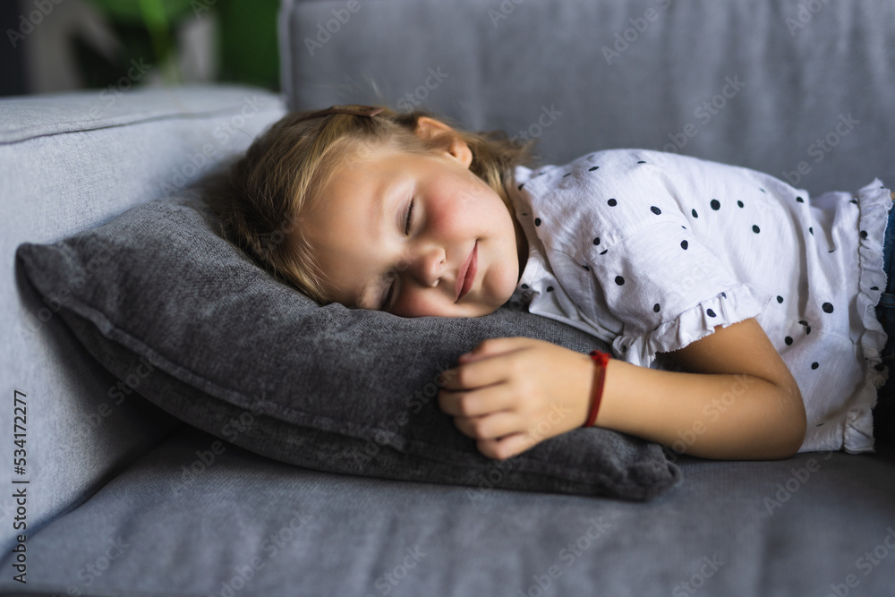 © F8  \ Suport Ukraine - Sweet dreams. Cute little preteen girl sleep dream nap on cozy couch lying in comfortable pose with closed eyes.