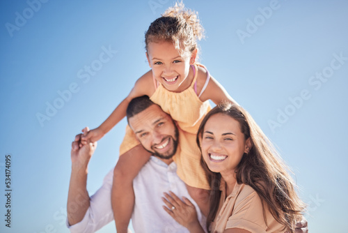 Parents, child and happy with sky in for portrait of family together outside on vacation. Mom, dad and girl on shoulders, love and happiness outdoors with blue sky while on holiday or travel
