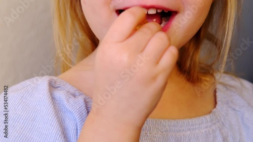 small child, blonde girl 3 years old wants to eat gelatinous sweets, gummy bear, kid has a good appetite, happy childhood, balanced diet, sweet life, unhealthy food, halal food photo