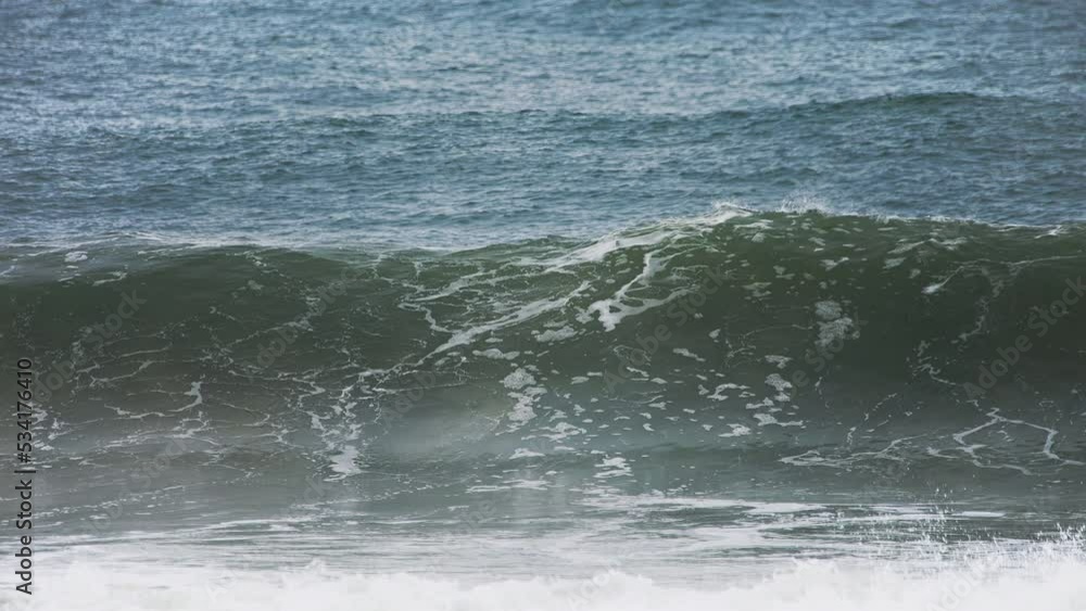 Big wave forming and crashing in slow motion in the shore with a deep dark blue ocean behind it and white water spilling in high speed camera 120fps 4K footage. Big wave forming and crashing in slow motion in the shore with a deep dark blue ocean behind it and white water spilling in high speed camera 120fps 4K footage.