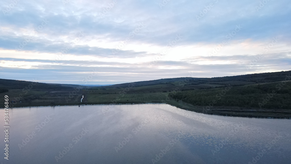 Fototapeta premium landscape drone picture moldova chisinau sunset sun clouds blue hour road forest farmland river