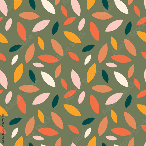 Autumn leaf fall on a green background. Seamless cute pattern with leaves or grains in different colors. Vector.