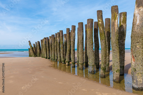 beach in france with wooden poles and the cahnnel between france and england
