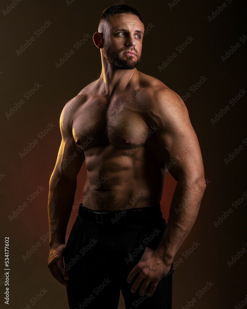© oleg_ermak - Portrait of a handsome muscular bodybuilder posing over warm dark background. Naked muscular torso, chest, biceps and abs © oleg_ermak - Portrait of a handsome muscular bodybuilder posing over warm dark background. Naked muscular torso, chest, biceps and abs