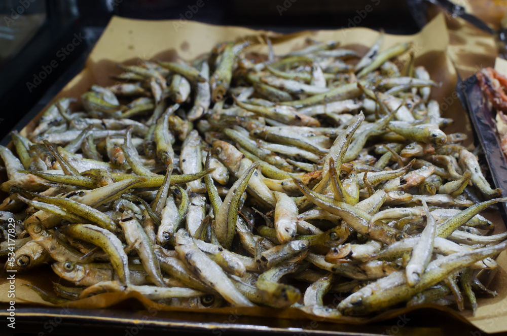 Delicious Fried anchovy small fish for sale. Fresh salty dish. The concept of Italian street food. Selective focus.