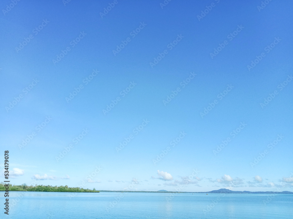 Beautiful seascape. The sea horizon, mountain and blue sky, natural photo background.
