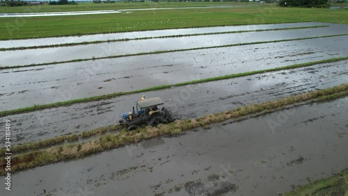 Tractors Ploughing The Paddy Rice Fields in Kedah, Malaysia