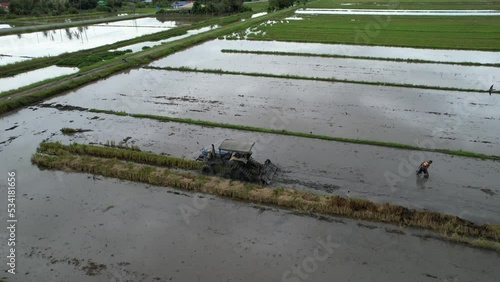 Tractors Ploughing The Paddy Rice Fields in Kedah, Malaysia
