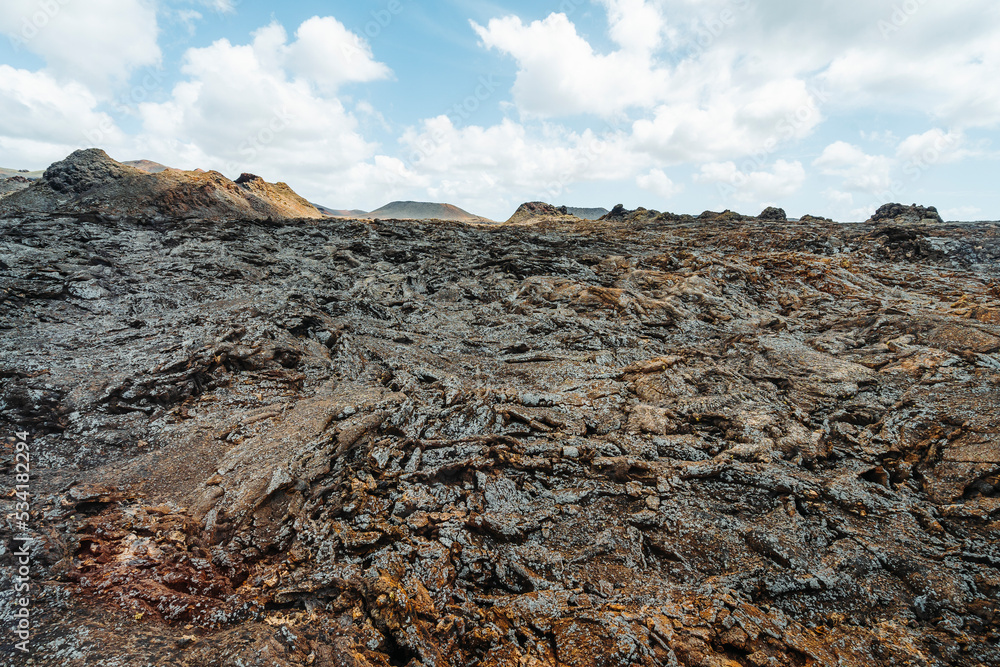 Arid volcanic landscape with lava fields in Timanfaya National Park, Lanzarote, Canary Island, Spain