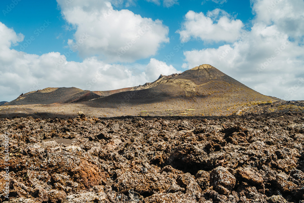 Arid volcanic landscape with lava fields in Timanfaya National Park, Lanzarote, Canary Island, Spain