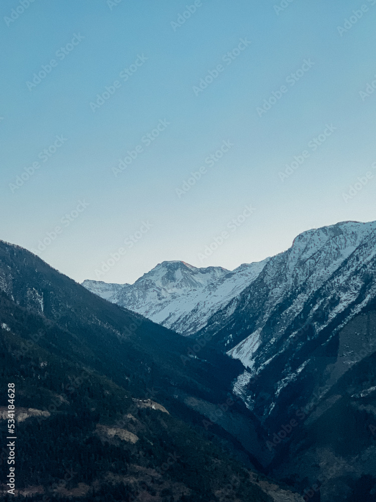 snowy mountains in the winter with a blue sky the alps ski snowboard blue hour darkness sunset