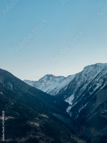 snowy mountains in the winter with a blue sky the alps ski snowboard blue hour darkness sunset © Youk