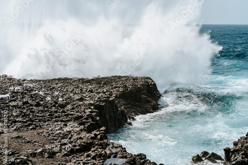 Water splash on black volcanic rocks of Tenesar, Lanzarote, Canary Islands