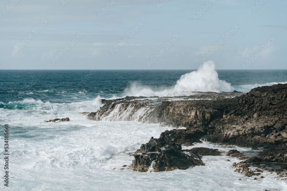 Water splash on black volcanic rocks of Tenesar, Lanzarote, Canary Islands