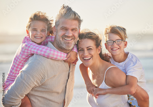 Foto Love, beach and parents with children portrait at sunset with piggy back ride family fun together