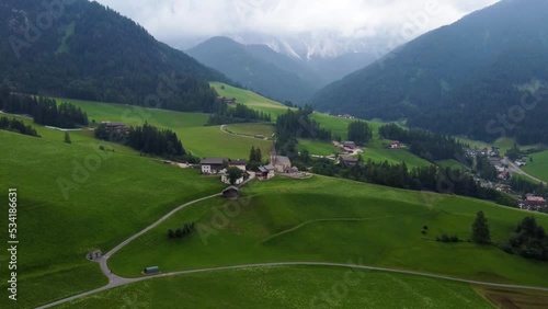 Aerial shot of the famous Santa Maddalena church, Odle Group in the background, Funes Valley, Italian Dolomites, from a drone. Trentino Alto Adige in summer photo