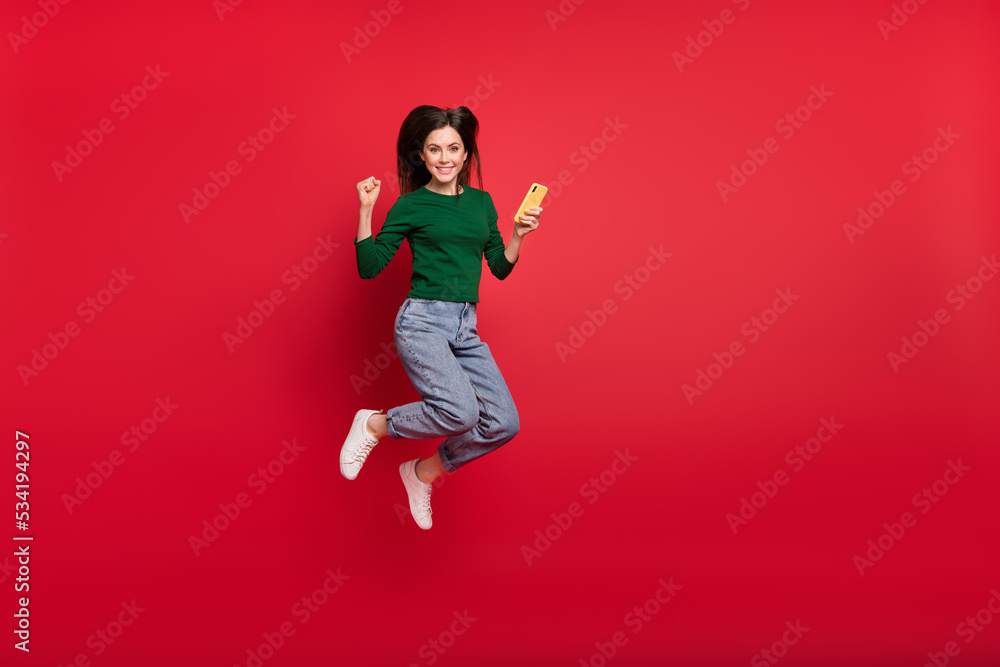 Full size photo of attractive lady influencer followers subscribe dressed stylish green outfit isolated on vivid red color background