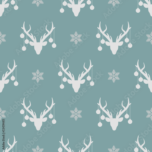 seamless winter pattern with grey silhouette of deer head with christmas tree toy balls on horns and snowflakes. vector flat Christmas ornament on powder blue background
