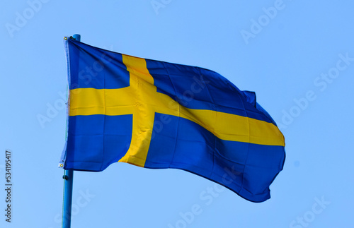 The flag of Sweden is a rectangular blue banner with a yellow Scandinavian cross