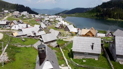 Prokosko lake, mountain Vranica, Bosnia and Herzegovina. Illegal construction of many houses. Aerial drone view of lake and houses.  photo