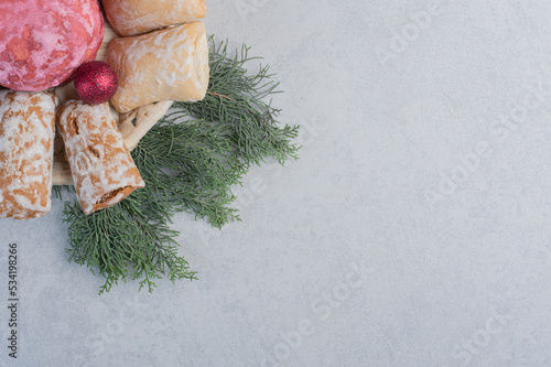 Cookies bundled in a white basket on a pile of pine branches
