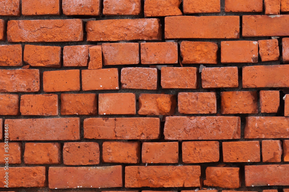 Old wall texture or background made of shabby rectangular red bricks. Old wall texture or background made of shabby rectangular red bricks.