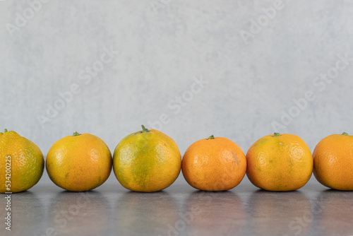 Delicious whole tangerines on marble background © azerbaijan-stockers