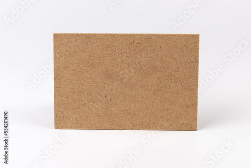 Brown cardboard sheet of paper on white background. Space for your disigne. © Olga