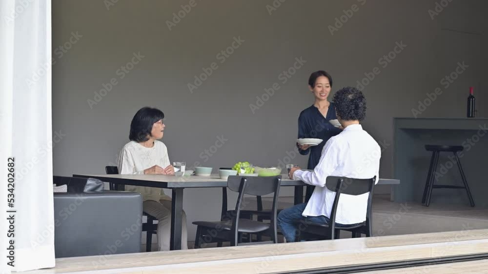 Wife serving food in dining room Cohabitation/Two-generation family Wide angle Wife serving food in dining room Cohabitation/Two-generation family Wide angle