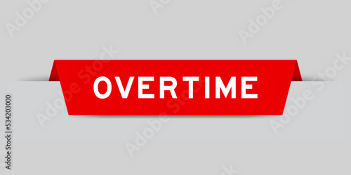 Red color inserted label with word overtime on gray background