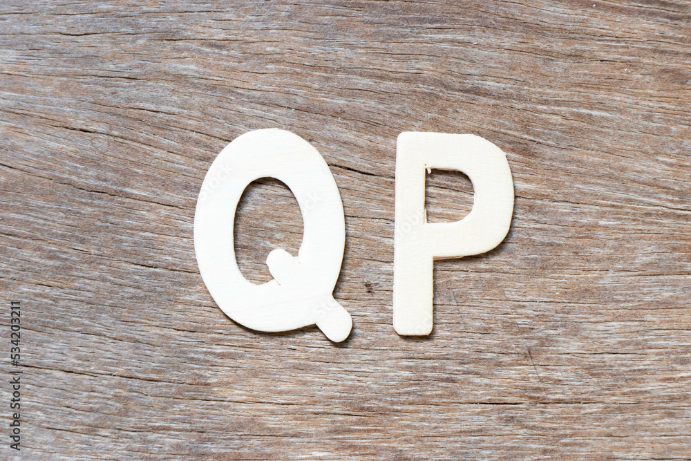Alphabet letter in word QP (Abbreviation of Quality procedure) on wood background Alphabet letter in word QP (Abbreviation of Quality procedure) on wood background
