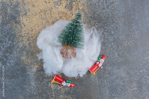 Two festive toys with Christmas tree and cotton wool